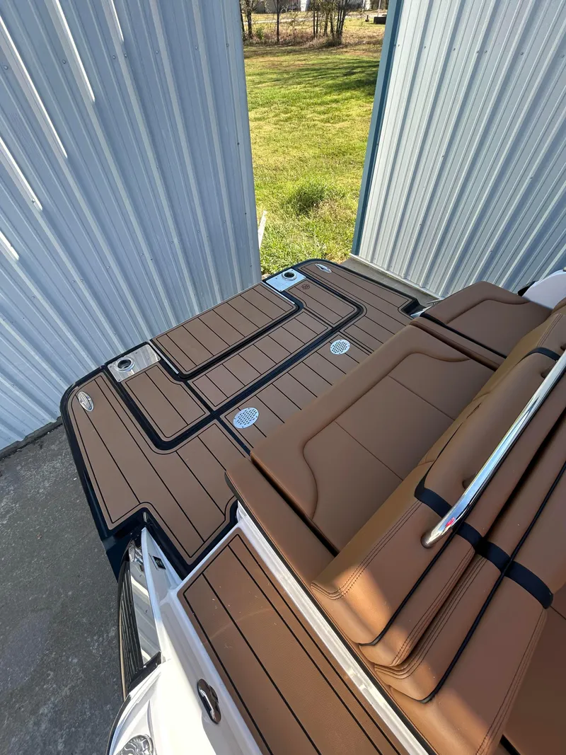 Slide: The Image of 2025 Chaparral 307 SSX boat deck with brown seating and sleek design. - 4