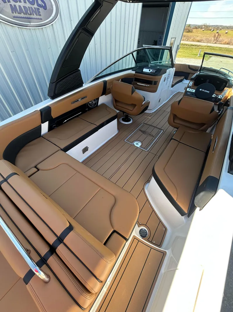 Slide: The Image of 2025 Chaparral 307 SSX boat interior with tan leather seating and modern dashboard. - 6