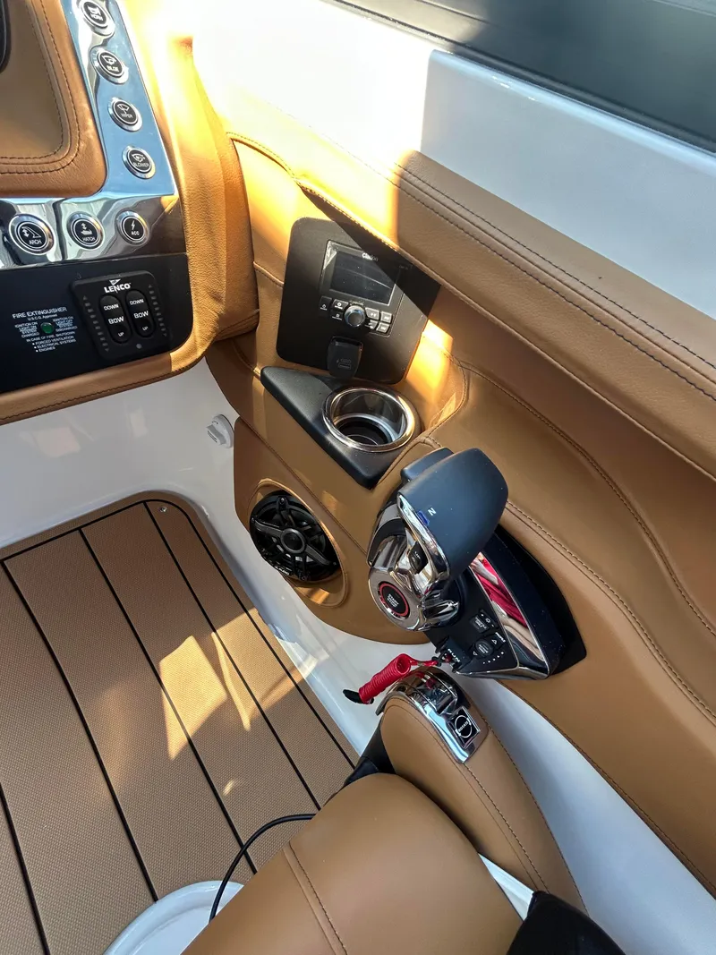 Slide: The Image of 2025 Chaparral 307 SSX boat interior with control panel and luxurious leather seating. - 9