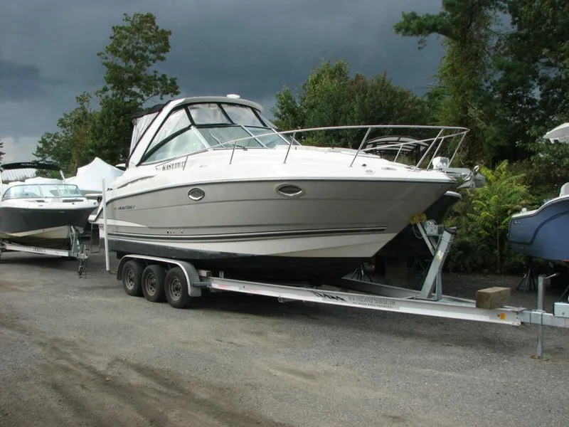 Slide: The Image of 2013 Monterey 280 Sport Yacht on trailer, parked outdoors under cloudy skies. - 0