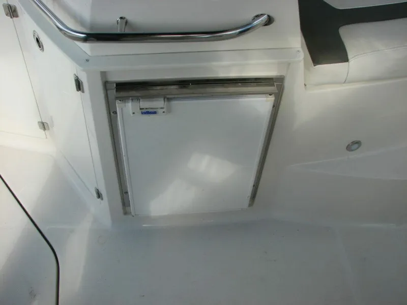 Slide: The Image of 2013 Monterey 280 Sport Yacht interior with built-in mini fridge. - 11
