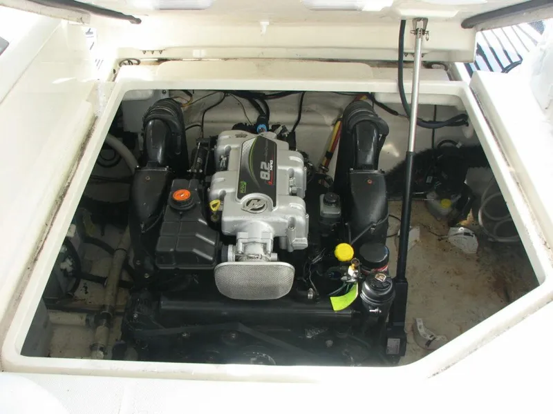 Slide: The Image of Engine compartment of 2013 Monterey 280 Sport Yacht, showcasing powerful marine engine. - 13