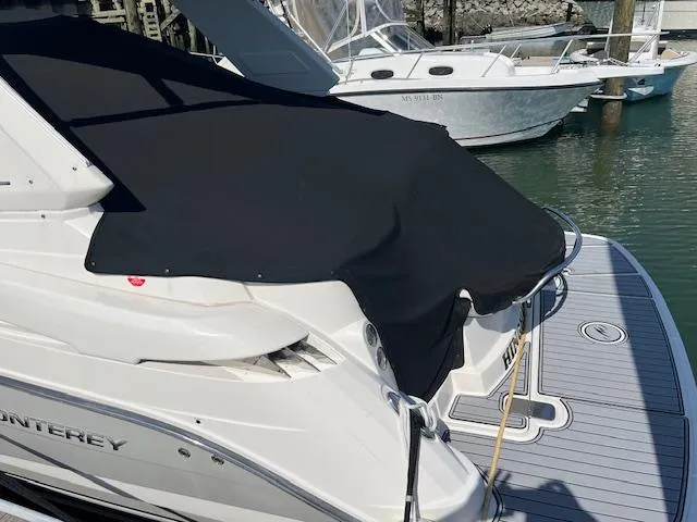 Slide: The Image of 2013 Monterey 280 Sport Yacht with black cover docked at marina. - 15