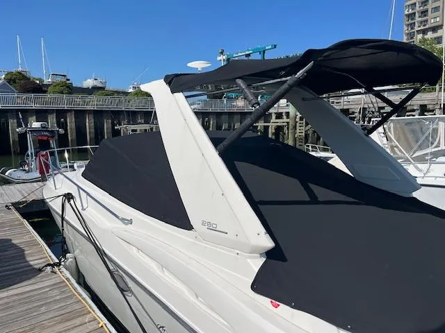 Slide: The Image of 2013 Monterey 280 Sport Yacht docked, featuring sleek design and black canopy. - 17
