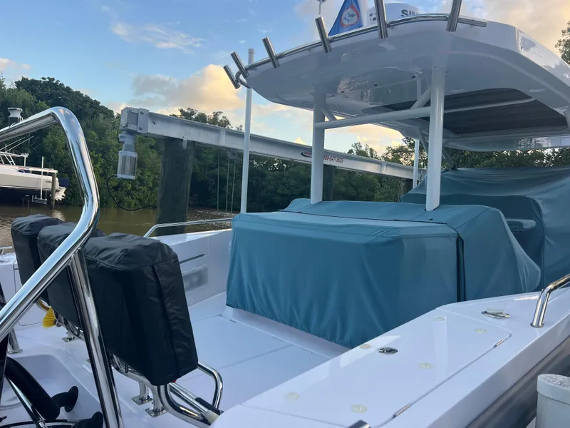 Slide: The Image of 2024 Axopar Sun Top boat docked, featuring sleek design and covered seating area. - 19