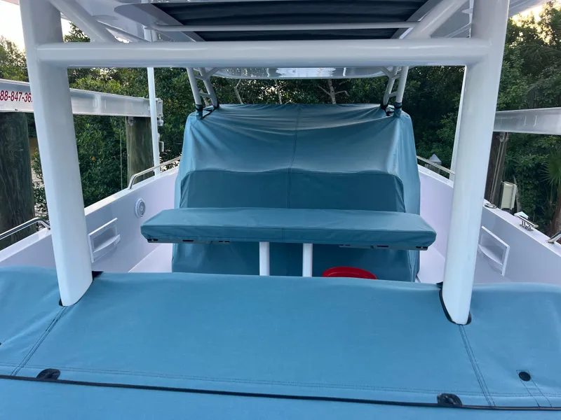 Slide: The Image of 2024 Axopar Sun Top boat with blue covers and sleek design. - 21