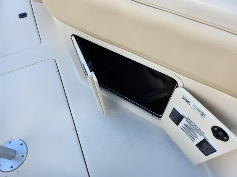 Slide: The Image of Open storage compartment on 2002 Sea Ray 240 Sundeck boat interior. - 11