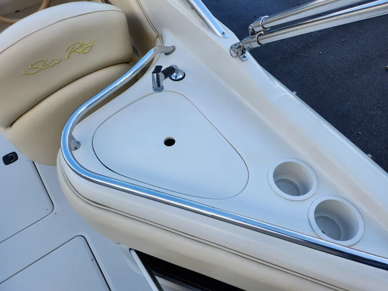 Slide: The Image of 2002 Sea Ray 240 Sundeck boat interior with sink and cup holders. - 12