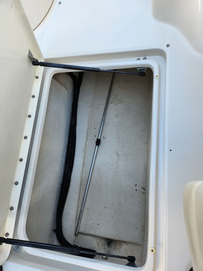 Slide: The Image of Open storage compartment on 2002 Sea Ray 240 Sundeck boat. - 15
