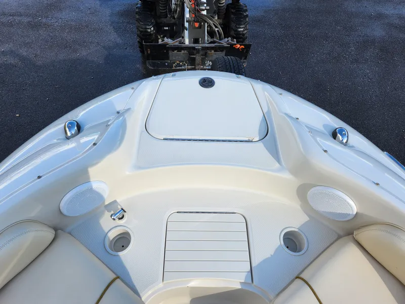 Slide: The Image of 2002 Sea Ray 240 Sundeck boat bow with seating and storage compartments. - 19