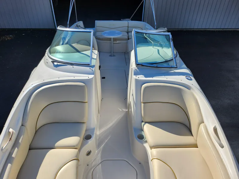 Slide: The Image of 2002 Sea Ray 240 Sundeck boat with beige seating and dual windshields. - 21
