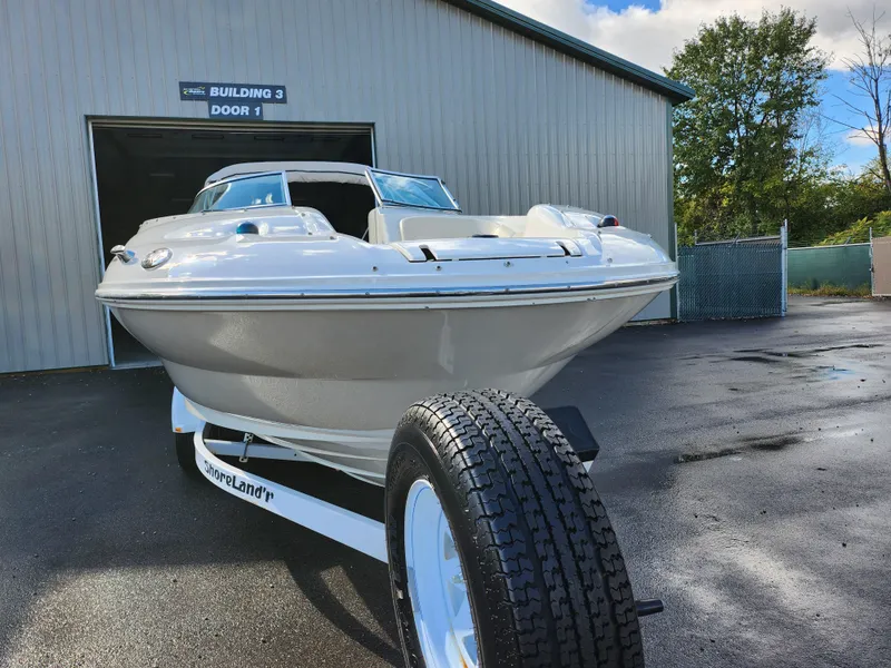 Slide: The Image of 2002 Sea Ray 240 Sundeck boat on trailer outside a building. - 6