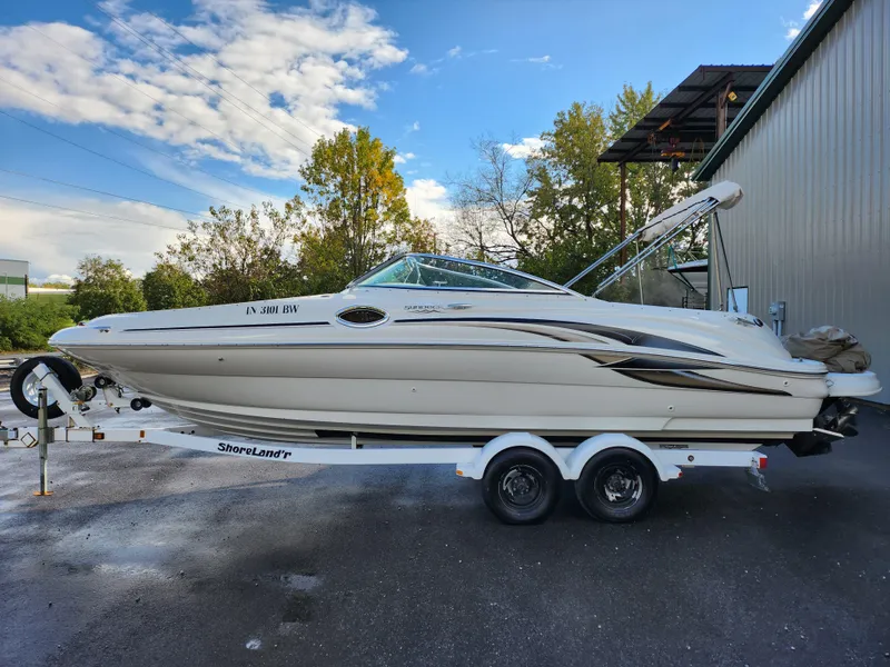 Slide: The Image of 2002 Sea Ray 240 Sundeck boat on trailer, parked outdoors. - 9