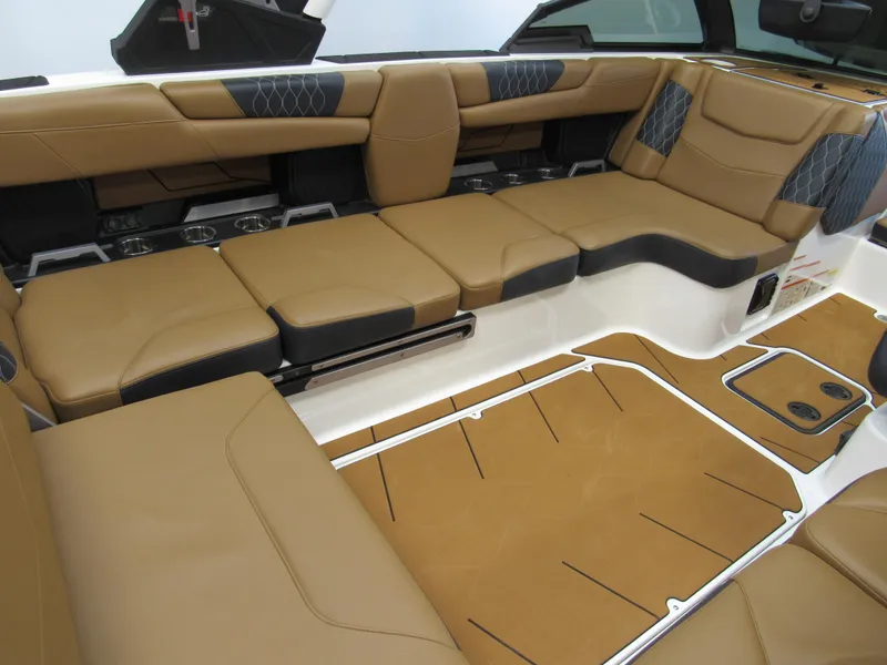 Slide: The Image of 2022 Malibu M220 boat interior with tan leather seating and modern design. - 11