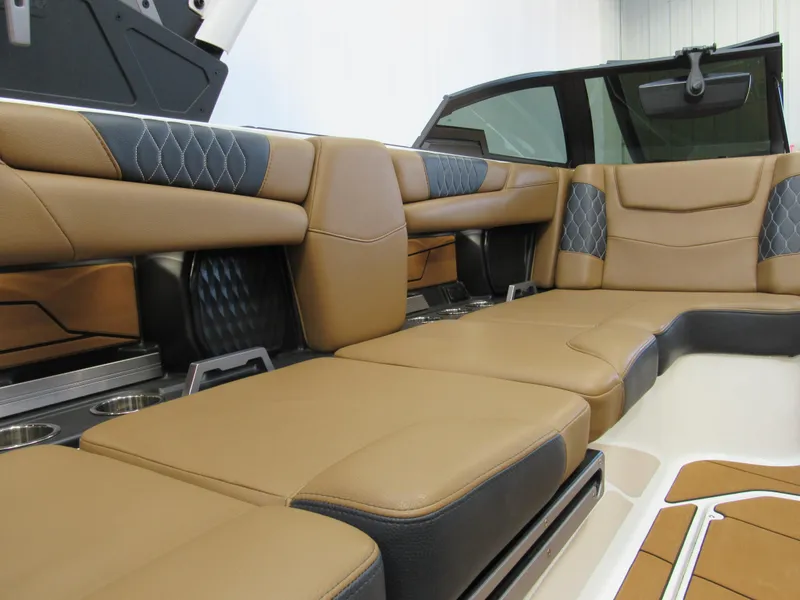 Slide: The Image of Luxurious interior of 2022 Malibu M220 boat with tan and black seating. - 12