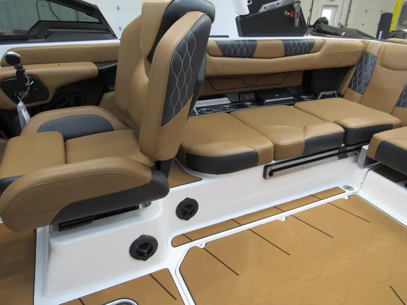 Slide: The Image of 2022 Malibu M220 boat interior with tan and black leather seating. - 13
