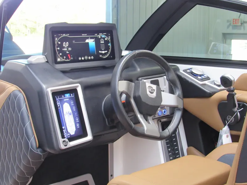 Slide: The Image of 2022 Malibu M220 boat dashboard with modern controls and digital displays. - 14
