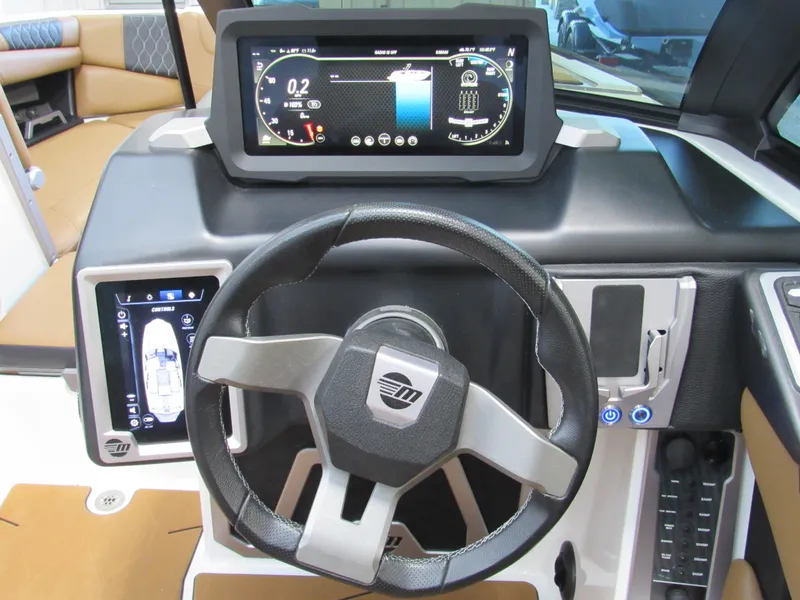 Slide: The Image of 2022 Malibu M220 boat dashboard with advanced digital controls and steering wheel. - 15