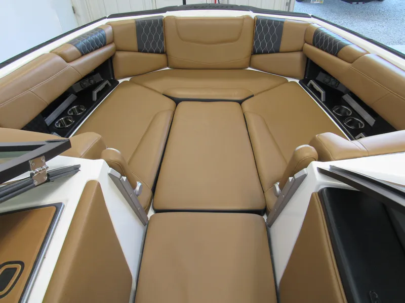 Slide: The Image of 2022 Malibu M220 boat interior with tan leather seating and modern design. - 18