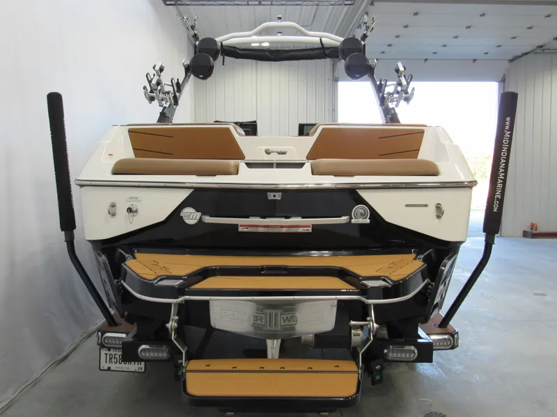 Slide: The Image of 2022 Malibu M220 boat rear view in a garage setting. - 4