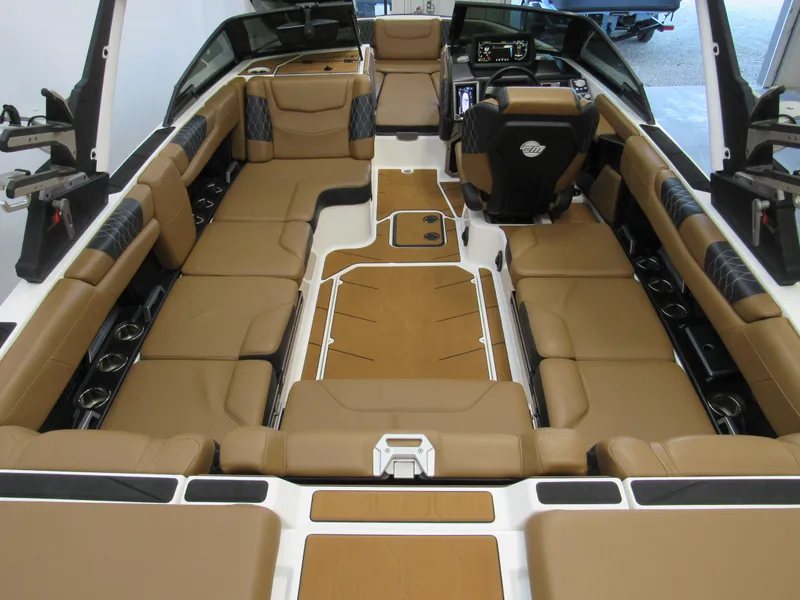 Slide: The Image of 2022 Malibu M220 boat interior with tan seating and modern dashboard. - 6