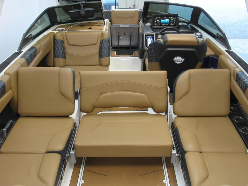 Slide: The Image of 2022 Malibu M220 boat interior with tan leather seating and modern dashboard. - 7