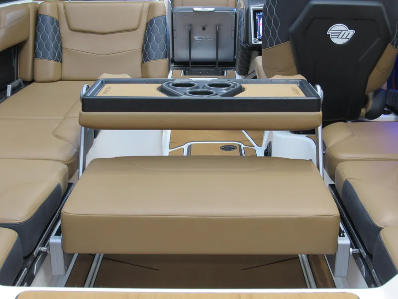 Slide: The Image of 2022 Malibu M220 boat interior with tan seating and cup holders. - 8