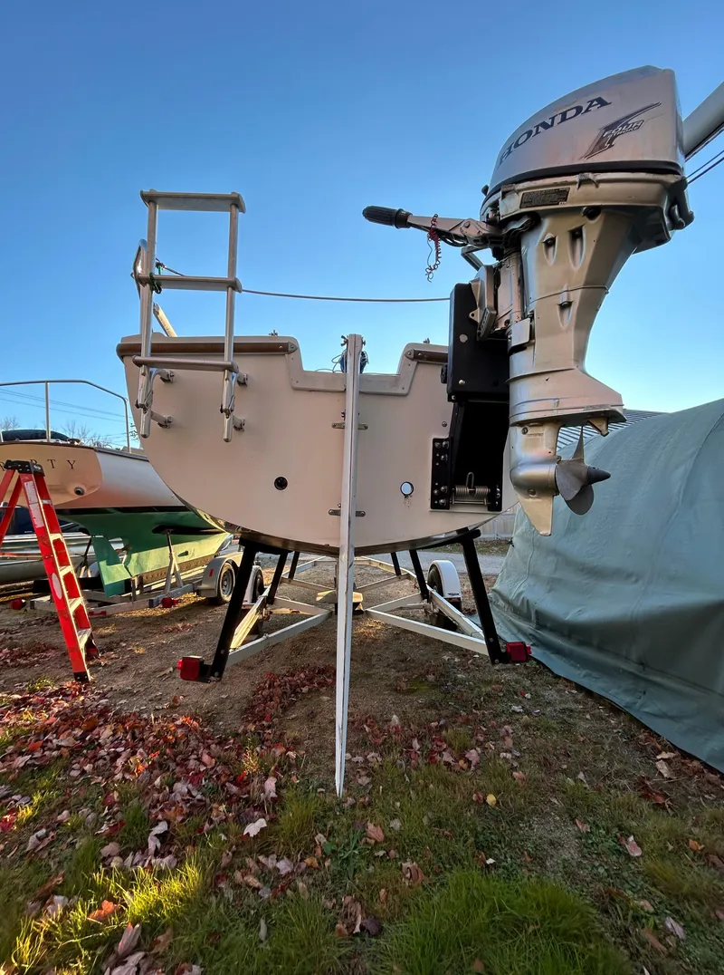 Slide: The Image of 1987 Catalina 22 Capri sailboat with Honda outboard motor on a trailer. - 10