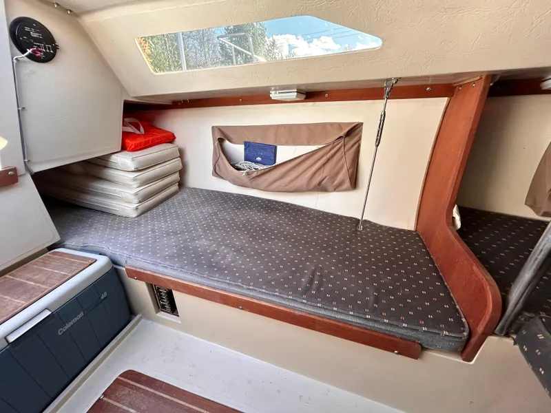 Slide: The Image of Interior cabin of 1987 Catalina 22 Capri sailboat with cushioned seating and storage. - 32