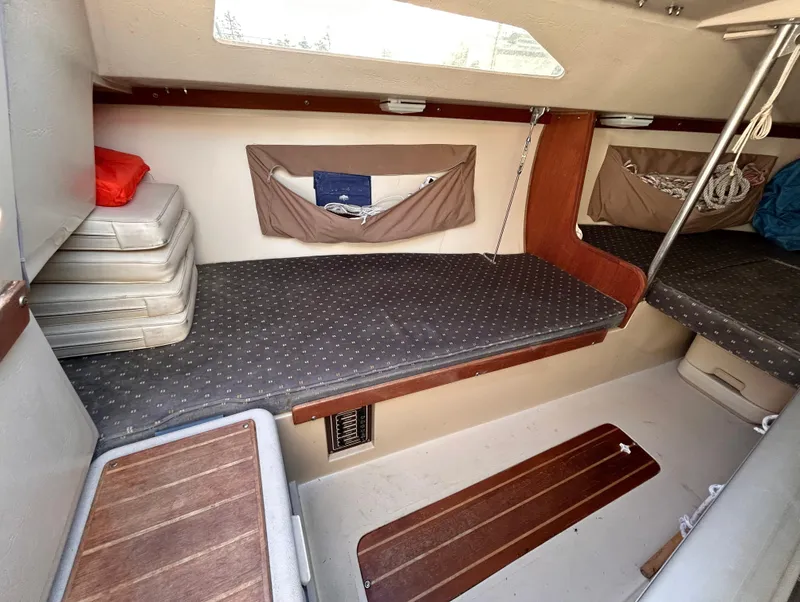 Slide: The Image of Interior of 1987 Catalina 22 Capri sailboat with cushioned seating and storage. - 34