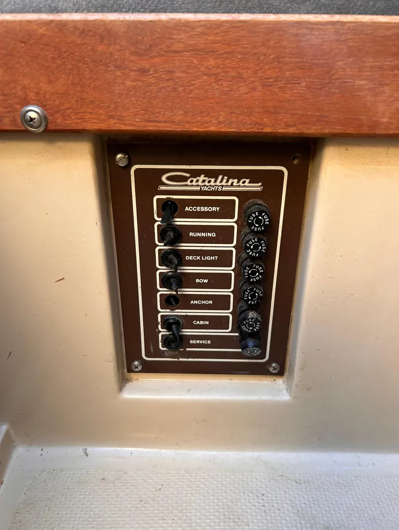 Slide: The Image of Control panel of a 1987 Catalina 22 Capri sailboat with labeled switches. - 37