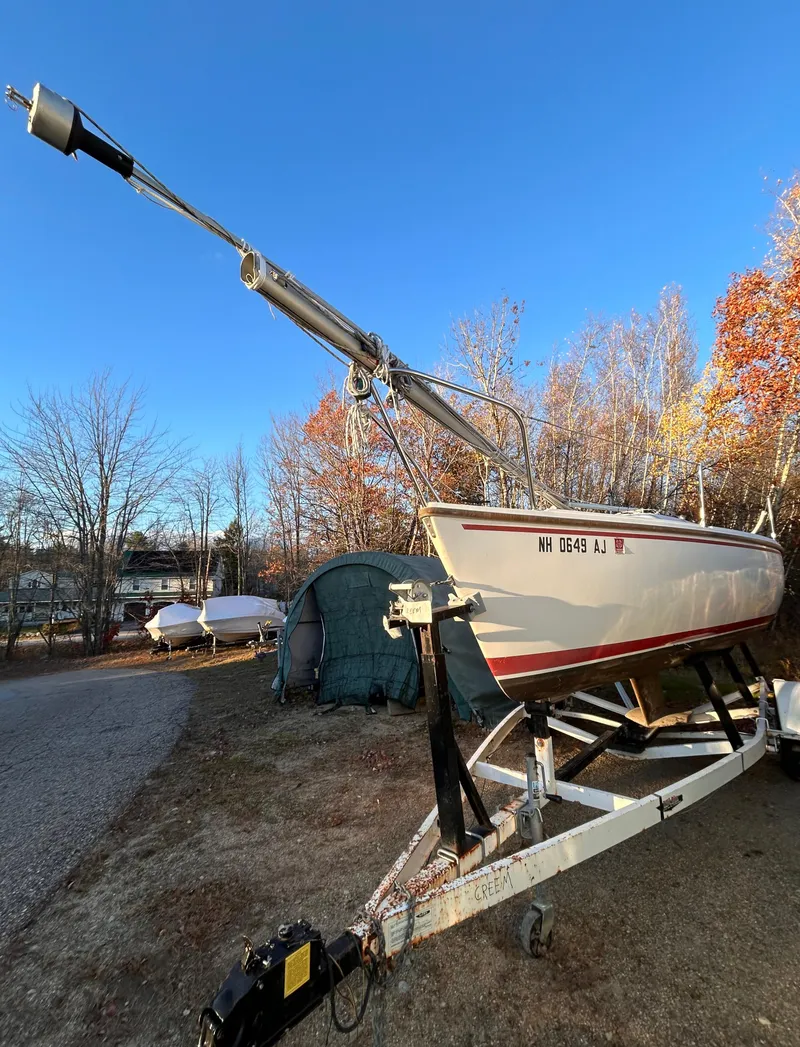 Slide: The Image of 1987 Catalina 22 Capri sailboat on trailer, surrounded by autumn trees. - 5