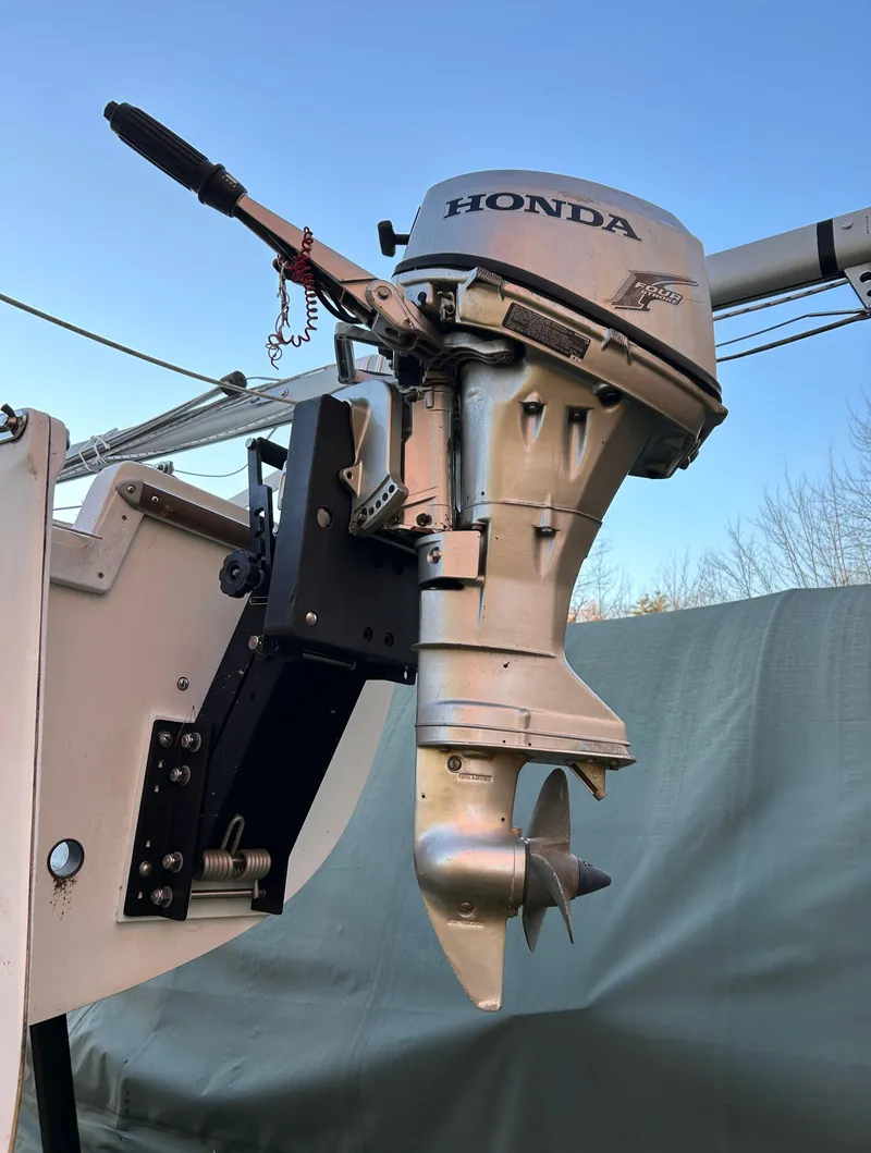 Slide: The Image of 1987 Catalina 22 Capri with Honda outboard motor, docked outdoors. - 6