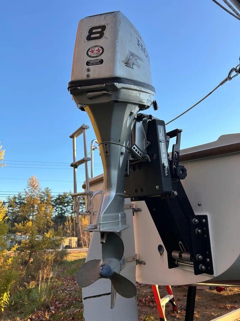 Slide: The Image of 1987 Catalina 22 Capri with outboard motor in sunny outdoor setting. - 8