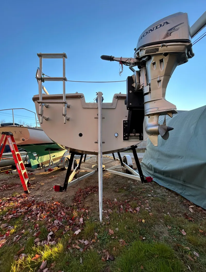 Slide: The Image of 1987 Catalina 22 Capri sailboat with Honda outboard motor, on land for maintenance. - 9