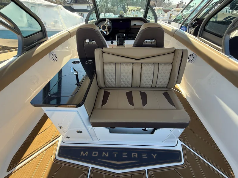 Slide: The Image of 2025 Monterey Elite 30 OB boat interior with luxurious seating and sleek design. - 11
