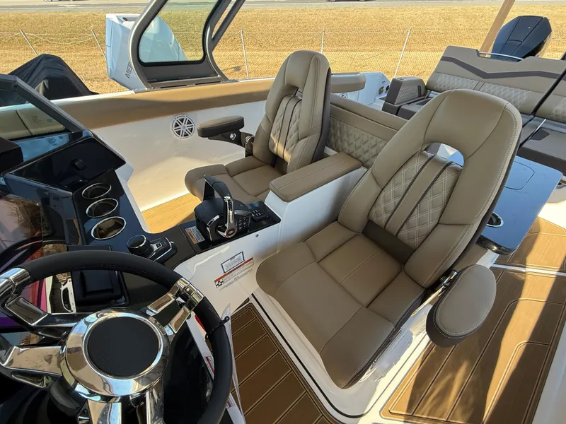 Slide: The Image of 2025 Monterey Elite 30 OB boat interior with luxurious seating and modern dashboard. - 15