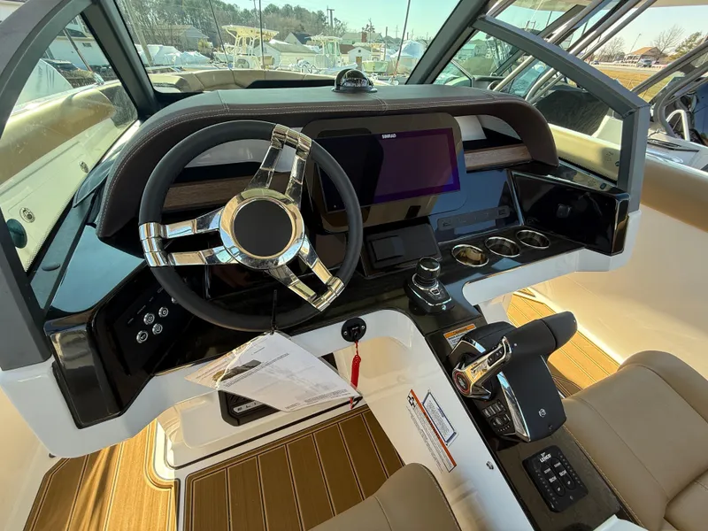 Slide: The Image of Cockpit of 2025 Monterey Elite 30 OB boat with modern steering and controls. - 16