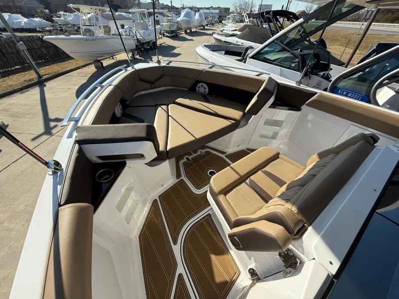 Slide: The Image of 2025 Monterey Elite 30 OB boat interior with tan seating and sleek design. - 18