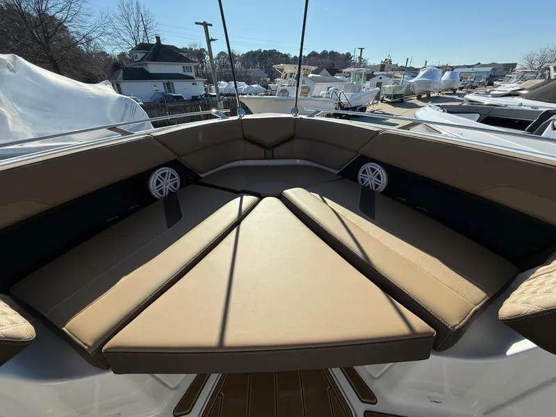 Slide: The Image of 2025 Monterey Elite 30 OB boat interior with tan seating and speakers. - 20