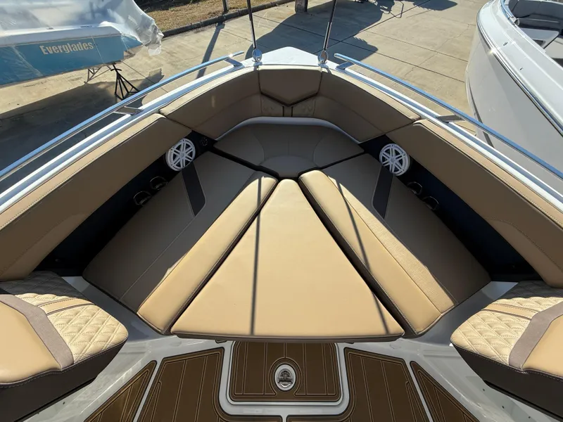 Slide: The Image of 2025 Monterey Elite 30 OB boat interior with tan seating and speakers. - 21