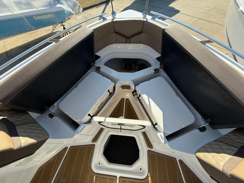 Slide: The Image of 2025 Monterey Elite 30 OB boat interior with cushioned seating and storage compartments. - 22