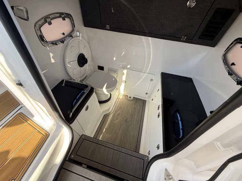 Slide: The Image of Interior of 2025 Monterey Elite 30 OB boat, featuring modern bathroom amenities. - 26