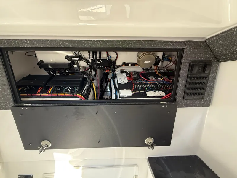 Slide: The Image of Electrical panel inside 2025 Monterey Elite 30 OB boat, showcasing wiring and components. - 28