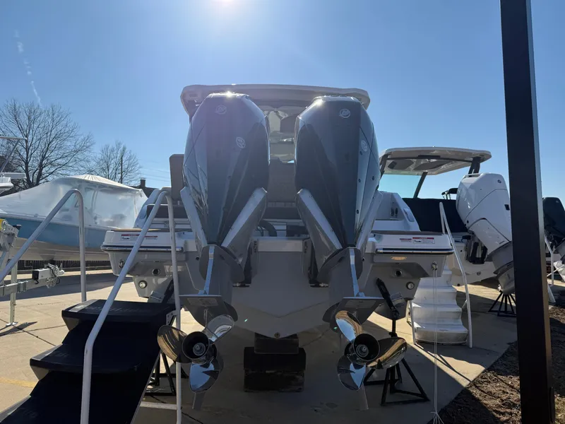 Slide: The Image of 2025 Monterey Elite 30 OB boat with dual outboard engines, displayed outdoors. - 3