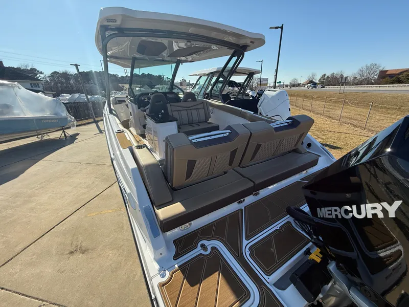Slide: The Image of 2025 Monterey Elite 30 OB boat with Mercury engine, docked outdoors. - 4