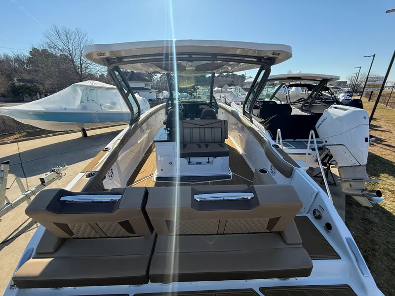 Slide: The Image of 2025 Monterey Elite 30 OB boat with spacious seating and modern design. - 6