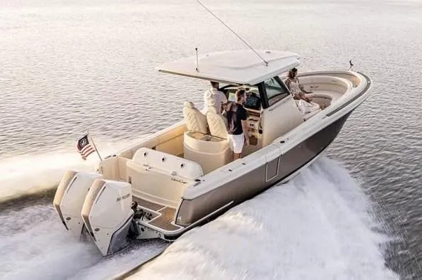 Slide: The Image of 2025 Chris-Craft Catalina 30 helm with modern controls and dual screens at a boat show. - 10