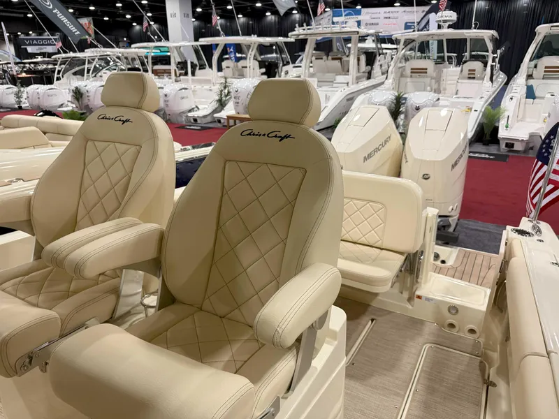 Slide: The Image of 2025 Chris-Craft Catalina 30 boat interior with luxurious seating at a boat show. - 11