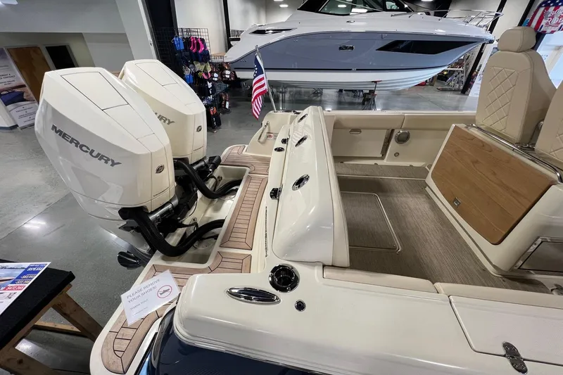 Slide: The Image of 2025 Chris-Craft Catalina 30 with dual Mercury engines, displayed indoors. - 15